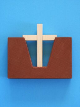 Une boîte en bois avec une croix en bois dessus.